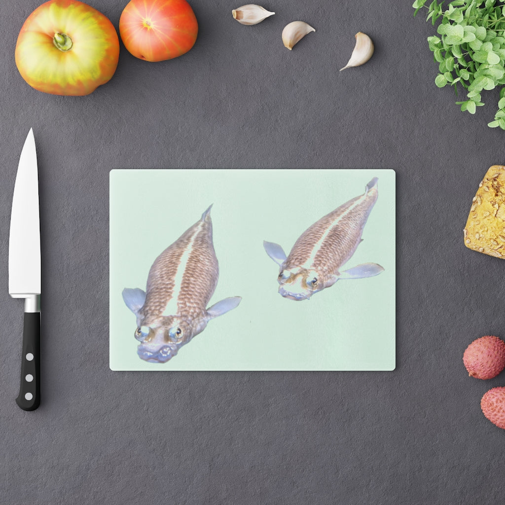 A beautifully designed Koi Fish Cutting Board made of tempered glass, featuring a unique Koi fish pattern and rubber dots for stability.