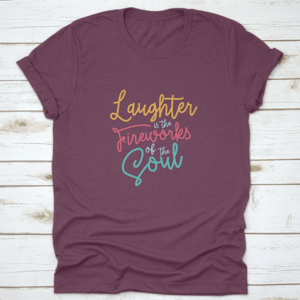 A motivational t-shirt featuring the phrase 'Laughter Is The Fireworks Of The Soul', made from soft cotton fabric.