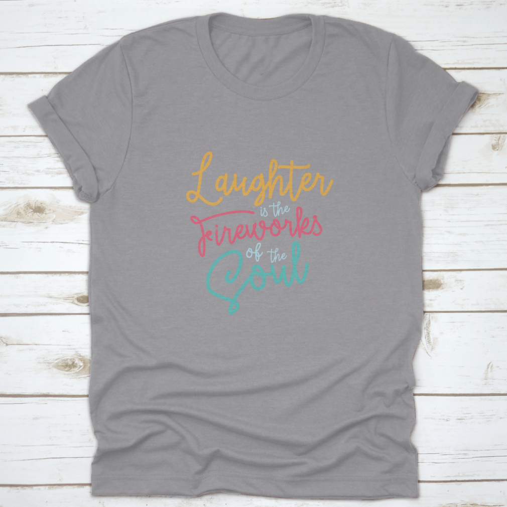 A motivational t-shirt featuring the phrase 'Laughter Is The Fireworks Of The Soul', made from soft cotton fabric.