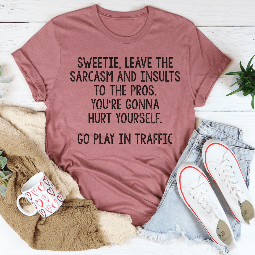 A comfortable and stylish t-shirt featuring the phrase 'Leave The Sarcasm And Insults To The Pros' printed on it, made from soft cotton.