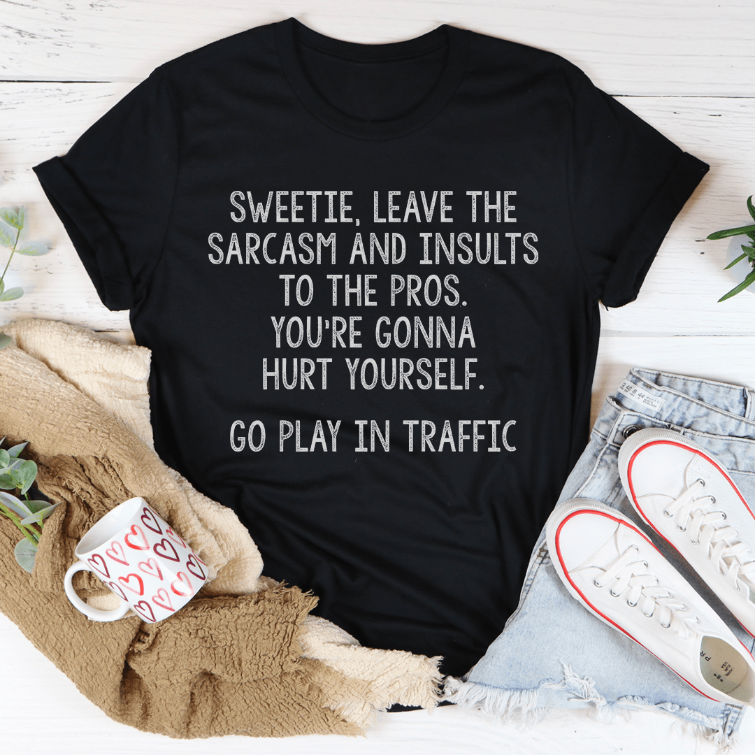 A comfortable and stylish t-shirt featuring the phrase 'Leave The Sarcasm And Insults To The Pros' printed on it, made from soft cotton.