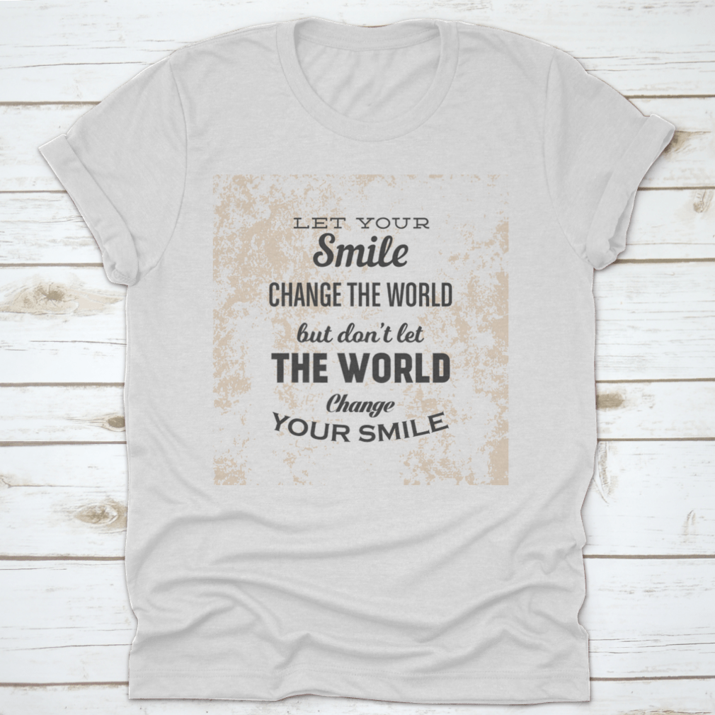 A stylish t-shirt featuring the phrase 'Let Your Smile Change The World' in a vibrant design, made from 100% cotton for comfort.