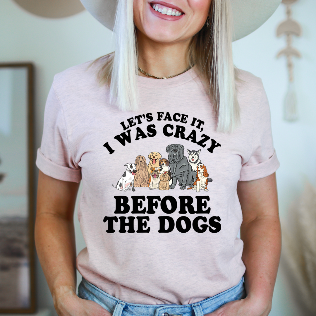 A comfortable and stylish t-shirt featuring the slogan 'Let's Face It I Was Crazy Before The Dogs', made from soft cotton.