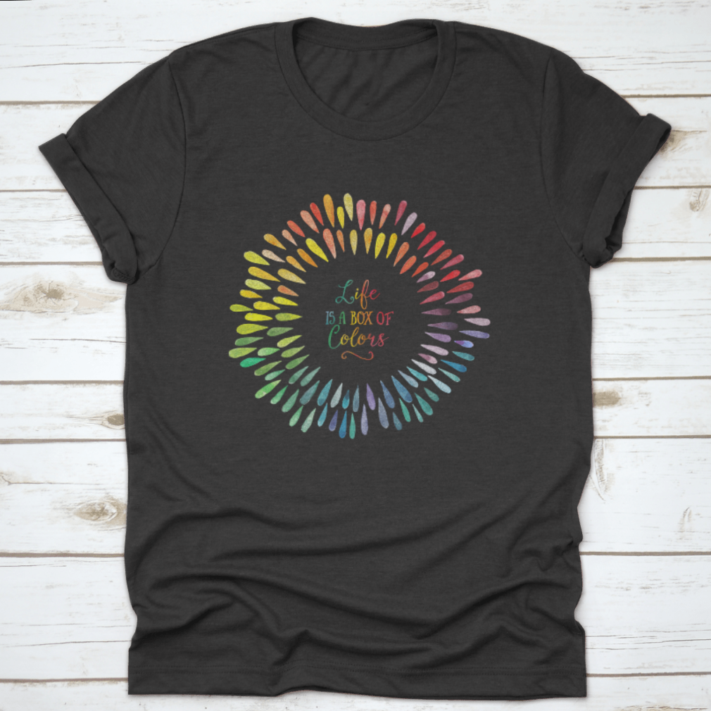 A stylish T-shirt featuring the motivational quote 'Life Is A Box Of Colors' in vibrant colors, made from 100% cotton for comfort.