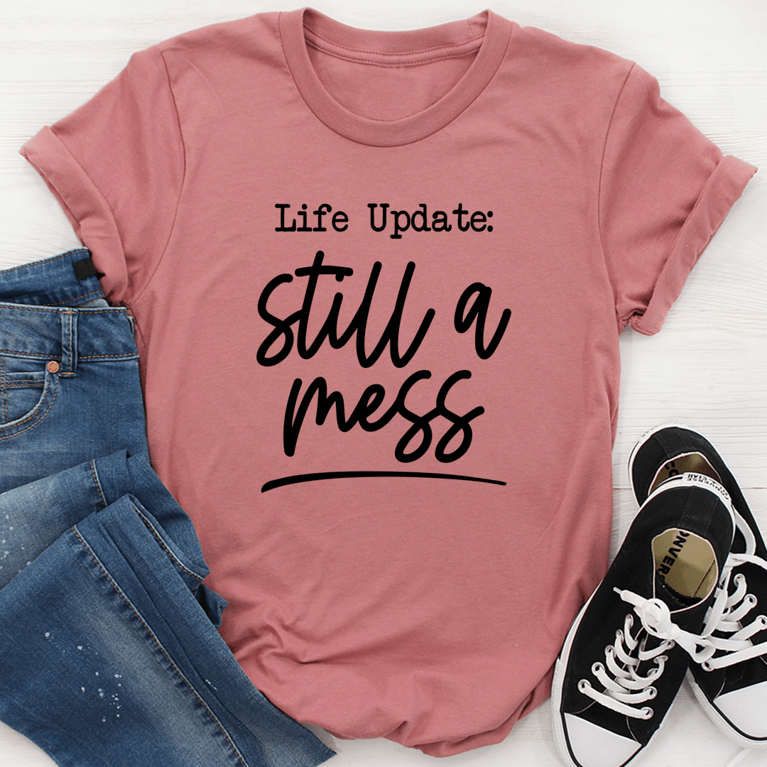 Life Update Still A Mess T-Shirt displayed on a mannequin, showcasing its soft cotton fabric and stylish design.