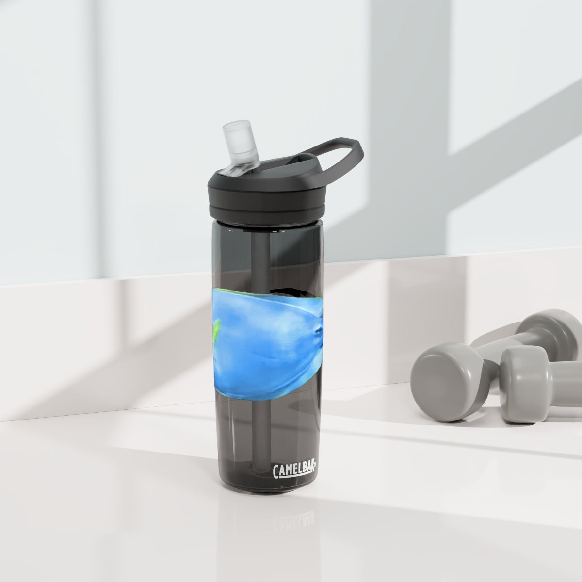 Light Blue and Yellow Fish CamelBak Eddy® Water Bottle, 20oz and 25oz sizes, featuring a spill-proof biting valve and easy-carry handle.