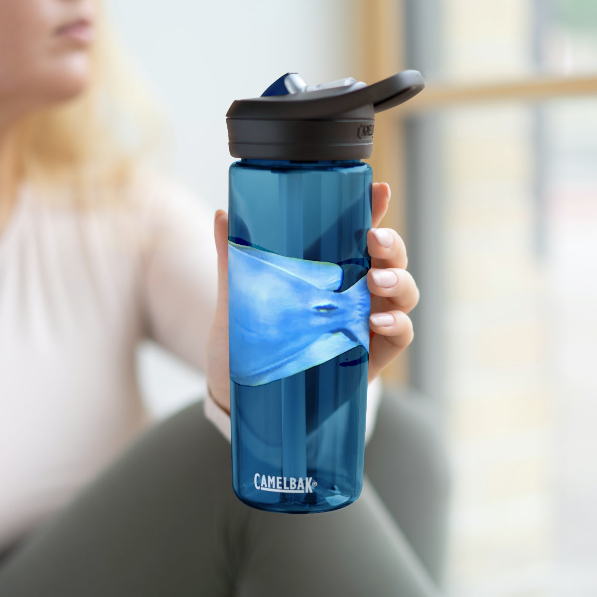 Light Blue and Yellow Fish CamelBak Eddy® Water Bottle, 20oz and 25oz sizes, featuring a spill-proof biting valve and easy-carry handle.