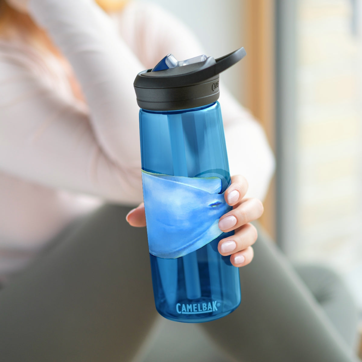 Light Blue and Yellow Fish CamelBak Eddy® Water Bottle, 20oz and 25oz sizes, featuring a spill-proof biting valve and easy-carry handle.