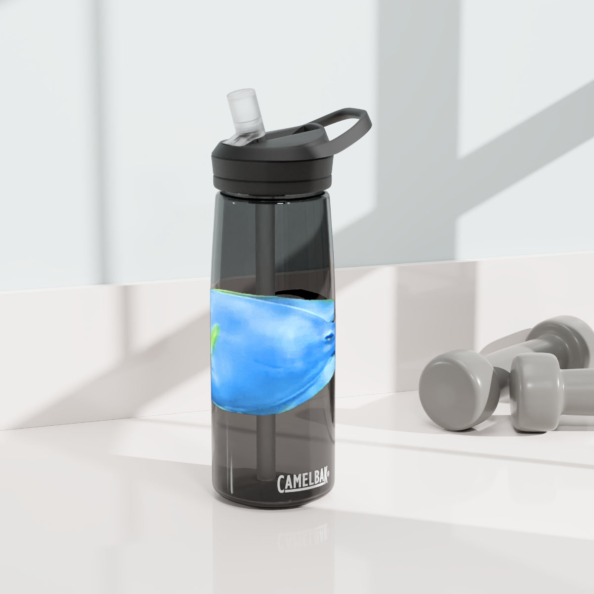 Light Blue and Yellow Fish CamelBak Eddy® Water Bottle, 20oz and 25oz sizes, featuring a spill-proof biting valve and easy-carry handle.