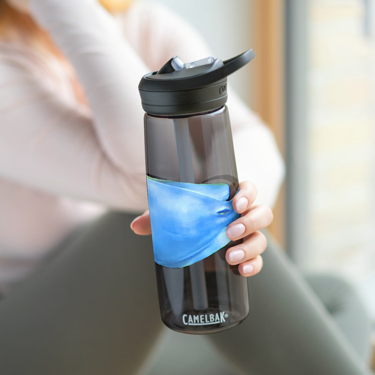 Light Blue and Yellow Fish CamelBak Eddy® Water Bottle, 20oz and 25oz sizes, featuring a spill-proof biting valve and easy-carry handle.