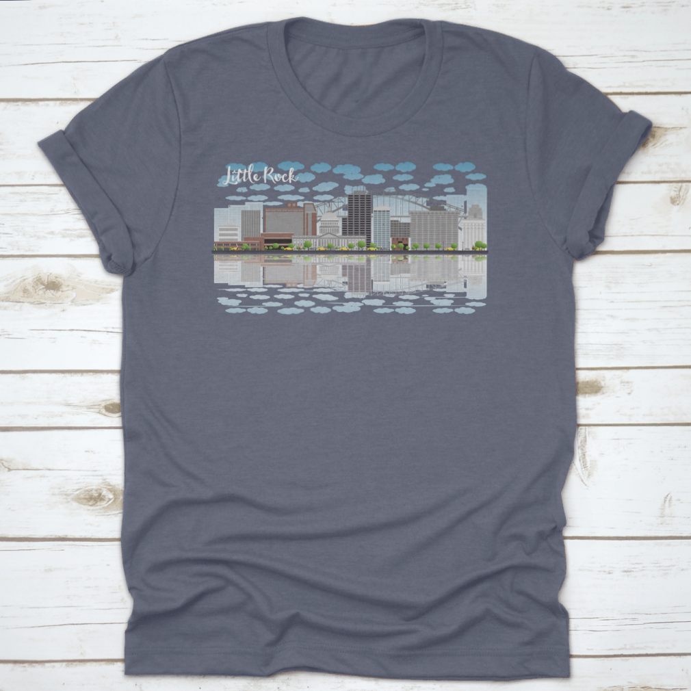 A stylish T-shirt featuring the Little Rock skyline with a grey building, blue sky, and reflections, showcasing urban beauty.