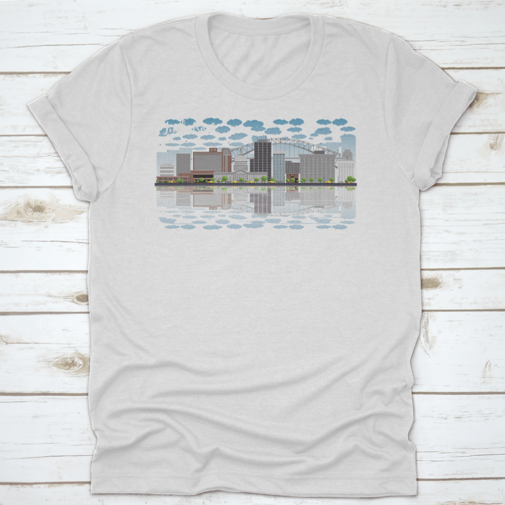 A stylish T-shirt featuring the Little Rock skyline with a grey building, blue sky, and reflections, showcasing urban beauty.