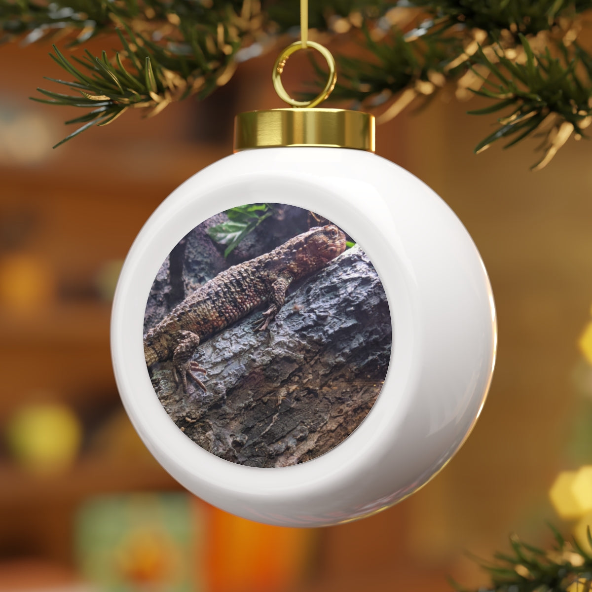 A beautifully crafted Lizard Christmas Ball Ornament featuring a glossy ceramic finish and a gold ribbon for hanging, showcasing a vintage style.