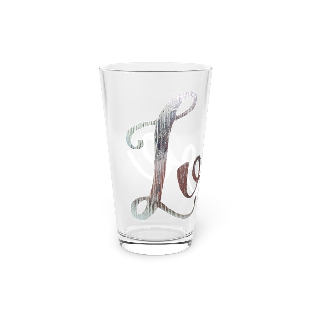 A clear 16oz Love Pint Glass showcasing a personalized design, perfect for beverages.