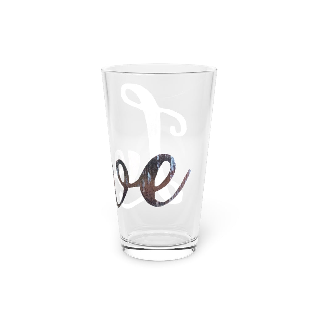 A clear 16oz Love Pint Glass showcasing a personalized design, perfect for beverages.