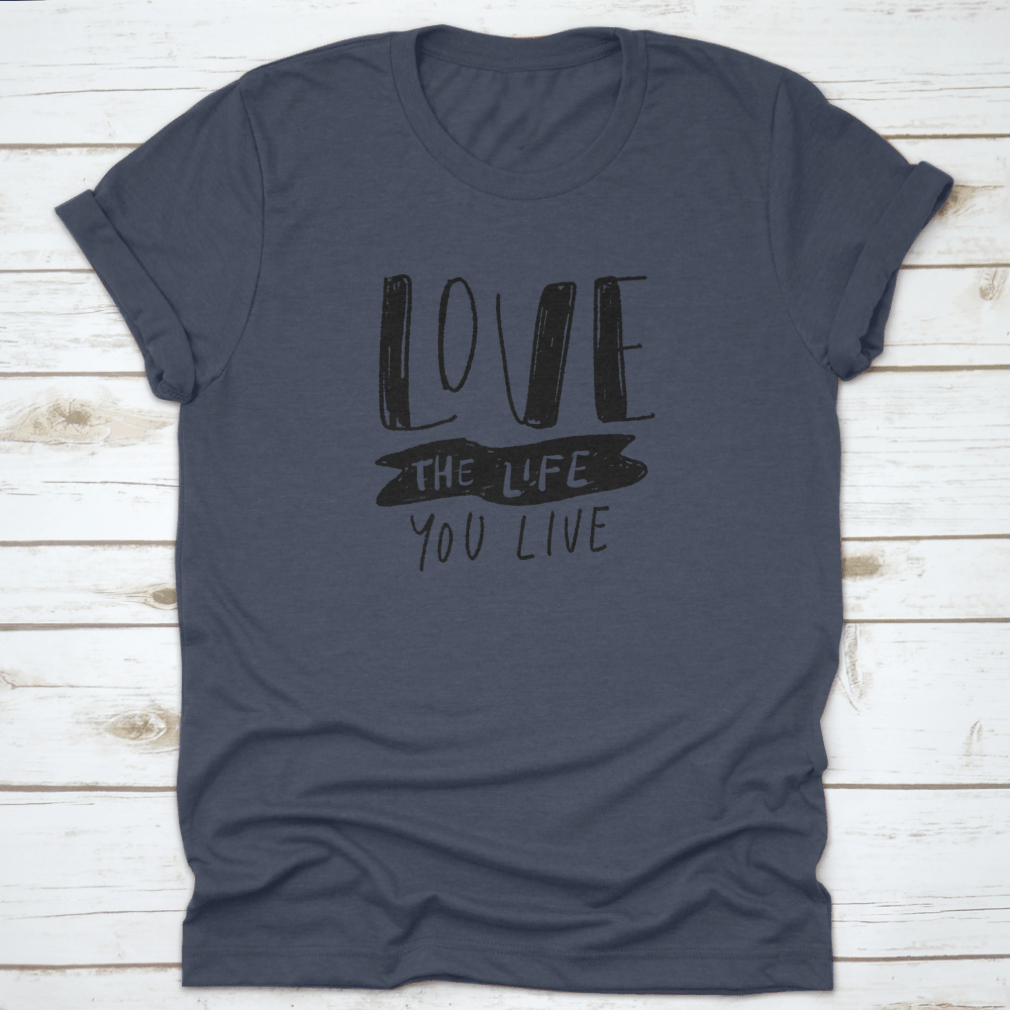 Hand lettering illustration saying 'Love The Life You Live' on a soft cotton fabric, showcasing its design and quality.