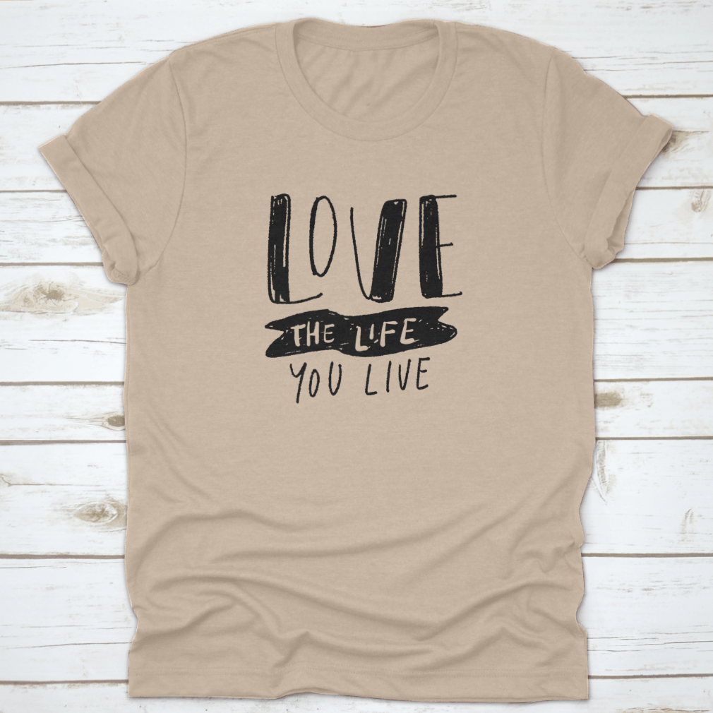 Hand lettering illustration saying 'Love The Life You Live' on a soft cotton fabric, showcasing its design and quality.