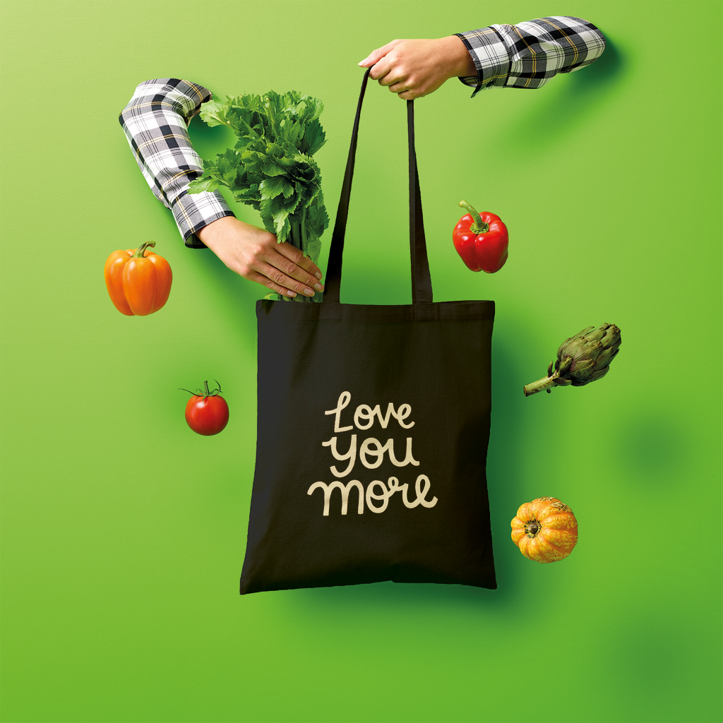 Love You More Shopper Tote Bag made of 100% cotton, featuring a spacious design and comfortable shoulder straps, ideal for eco-friendly shopping.