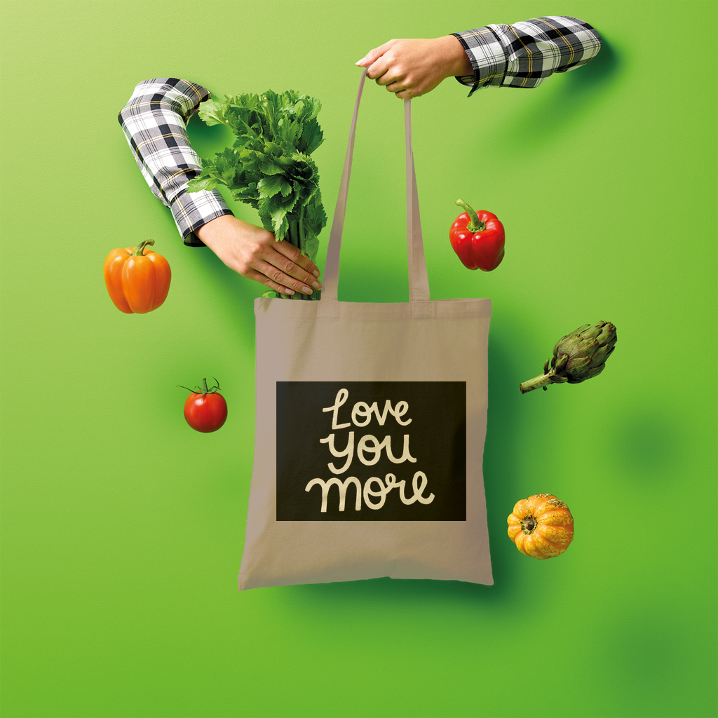 Love You More Shopper Tote Bag made of 100% cotton, featuring a spacious design and comfortable shoulder straps, ideal for eco-friendly shopping.