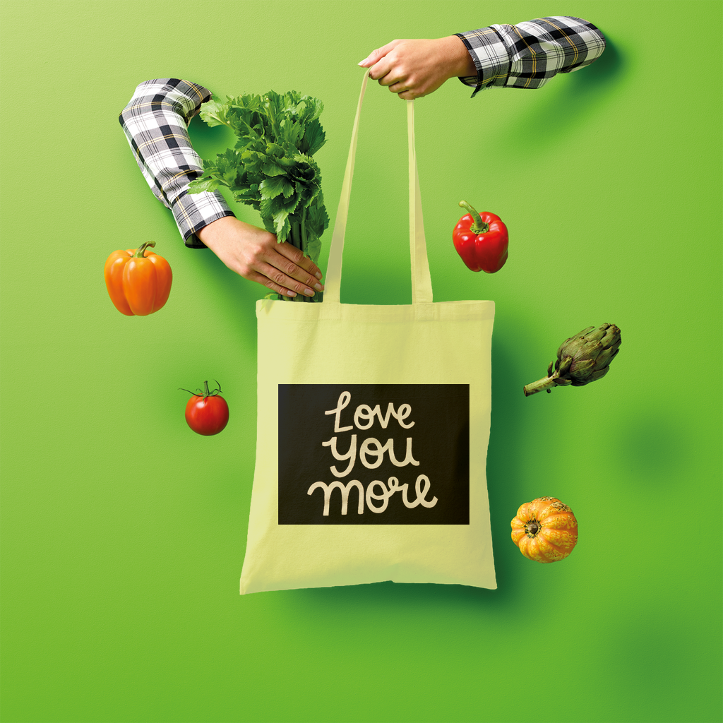 Love You More Shopper Tote Bag made of 100% cotton, featuring a spacious design and comfortable shoulder straps, ideal for eco-friendly shopping.