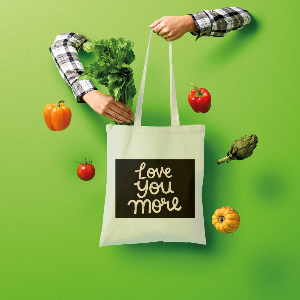 Love You More Shopper Tote Bag made of 100% cotton, featuring a spacious design and comfortable shoulder straps, ideal for eco-friendly shopping.