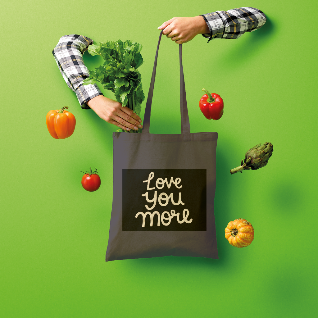 Love You More Shopper Tote Bag made of 100% cotton, featuring a spacious design and comfortable shoulder straps, ideal for eco-friendly shopping.