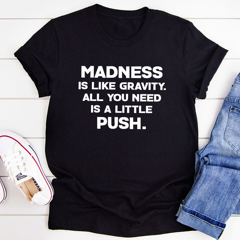 Madness Is Like Gravity T-Shirt displayed on a mannequin, showcasing its soft cotton fabric and vibrant print.