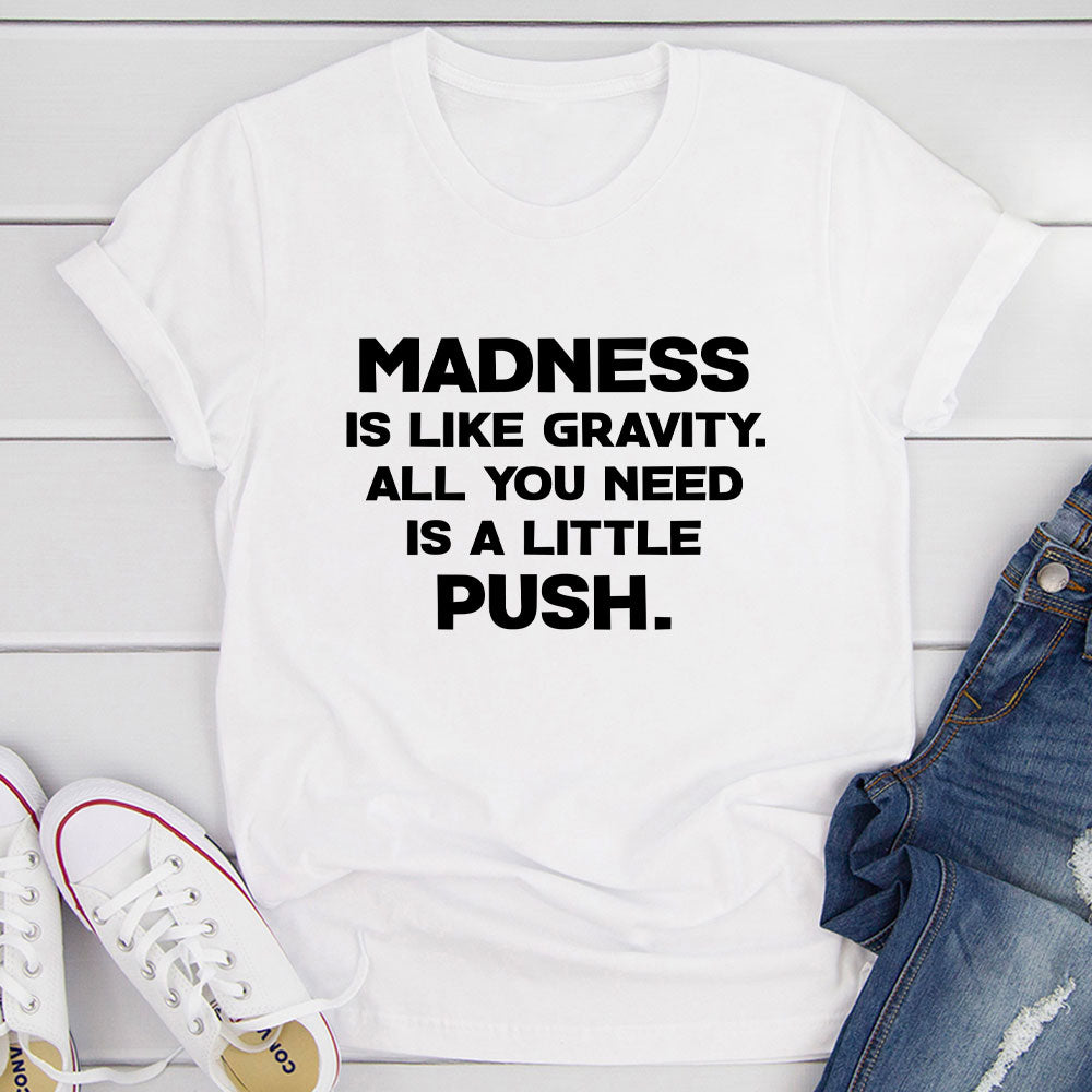 Madness Is Like Gravity T-Shirt displayed on a mannequin, showcasing its soft cotton fabric and vibrant print.