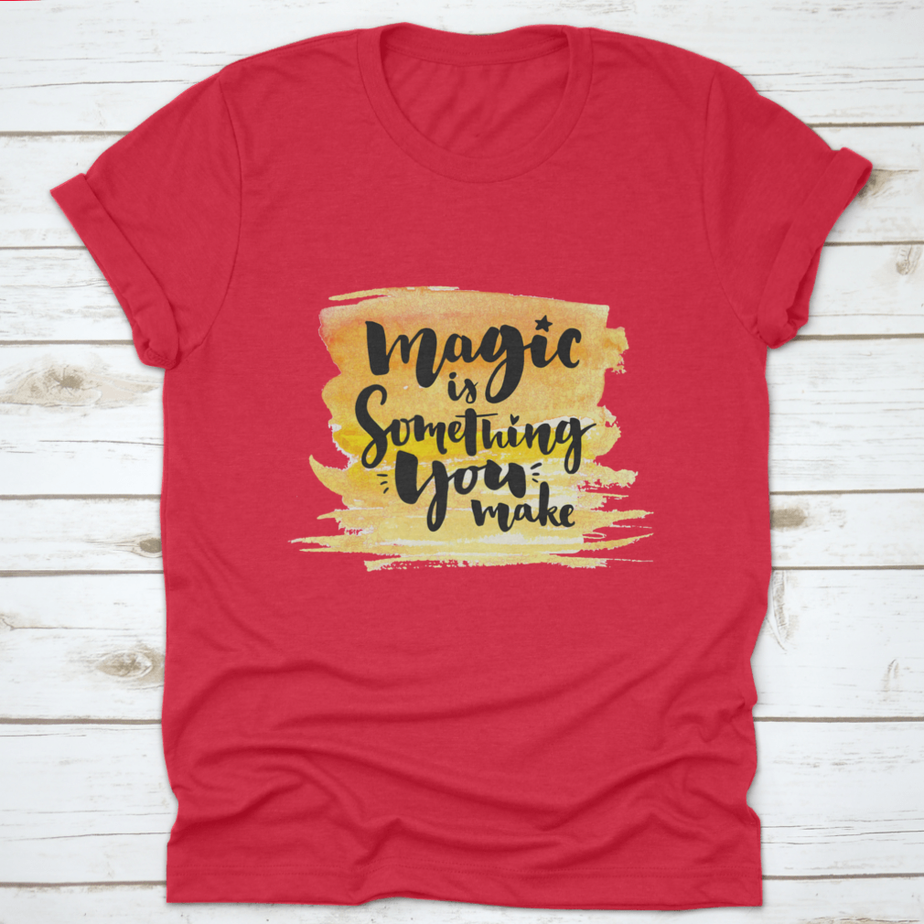 A vibrant yellow watercolor background featuring the phrase 'Magic Is Something You Make' in elegant brush lettering, showcasing creativity and artistic expression.