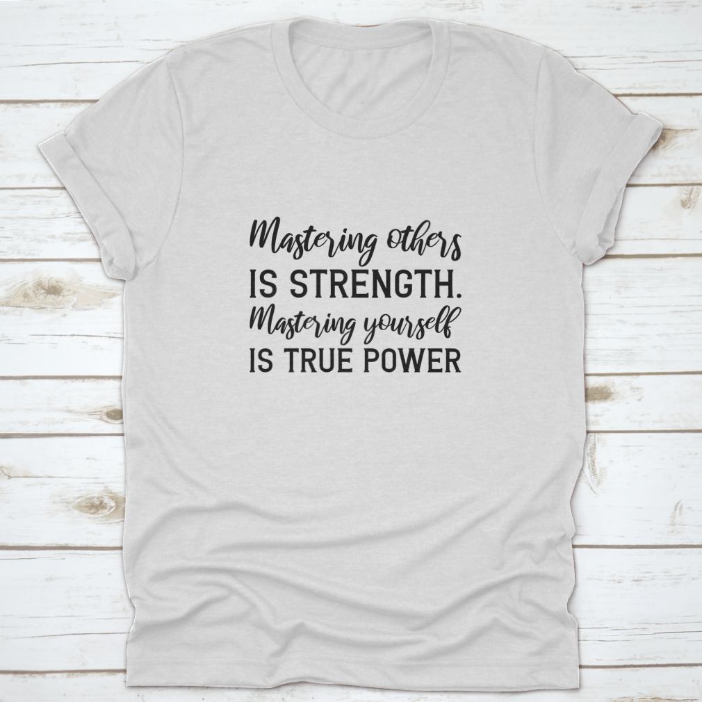 A stylish T-shirt featuring the quote 'Mastering Others Is Strength. Mastering Yourself Is True Power.' in a classic fit, made from 100% cotton.