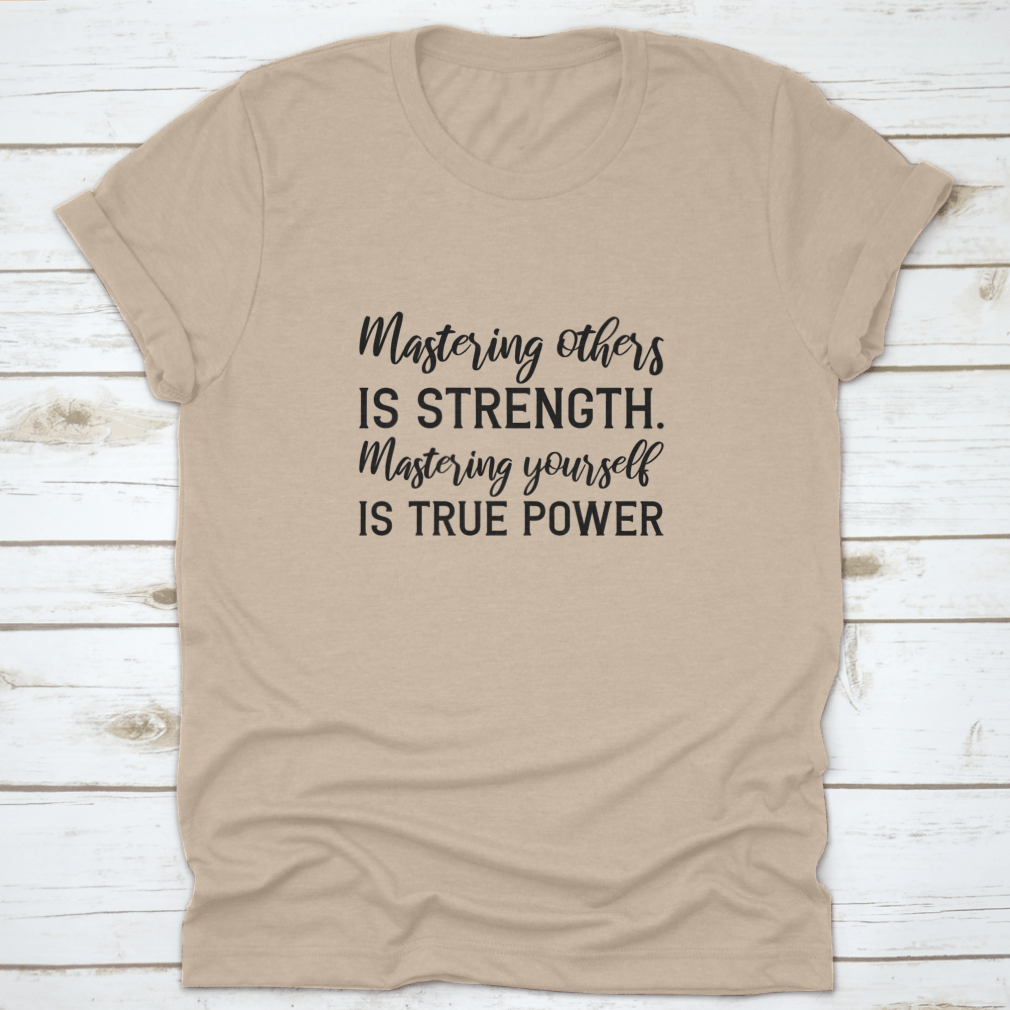 A stylish T-shirt featuring the quote 'Mastering Others Is Strength. Mastering Yourself Is True Power.' in a classic fit, made from 100% cotton.