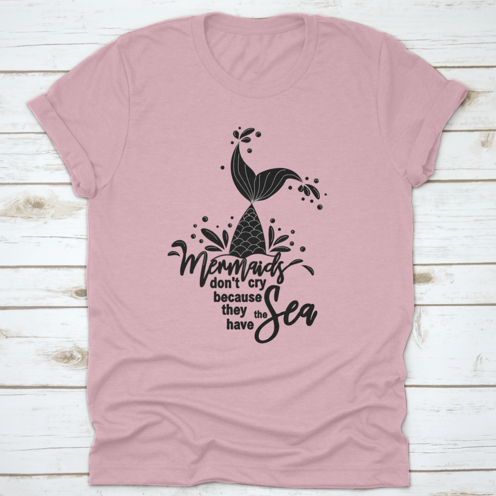 A stylish t-shirt featuring the phrase 'Mermaids Don't Cry Because They Have The Sea' with a whimsical mermaid design, perfect for ocean lovers.