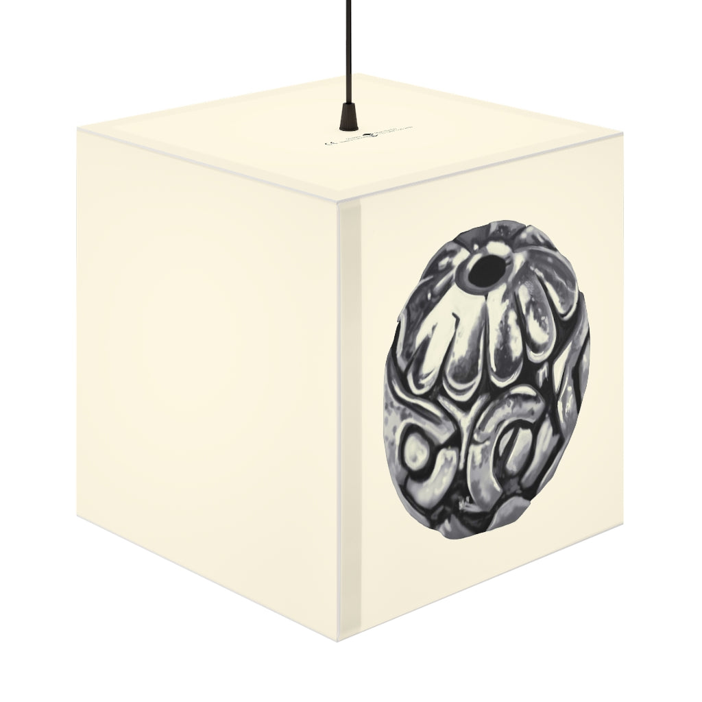 A stylish Metal Piece Personalized Lamp in a cube shape, showcasing its unique design and warm glow, perfect for indoor decor.