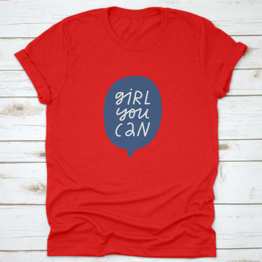 A stylish t-shirt featuring minimalist hand-drawn lettering in a blue speech bubble that reads 'Girl You Can', showcasing a casual and empowering design.