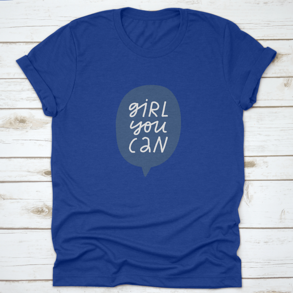 A stylish t-shirt featuring minimalist hand-drawn lettering in a blue speech bubble that reads 'Girl You Can', showcasing a casual and empowering design.