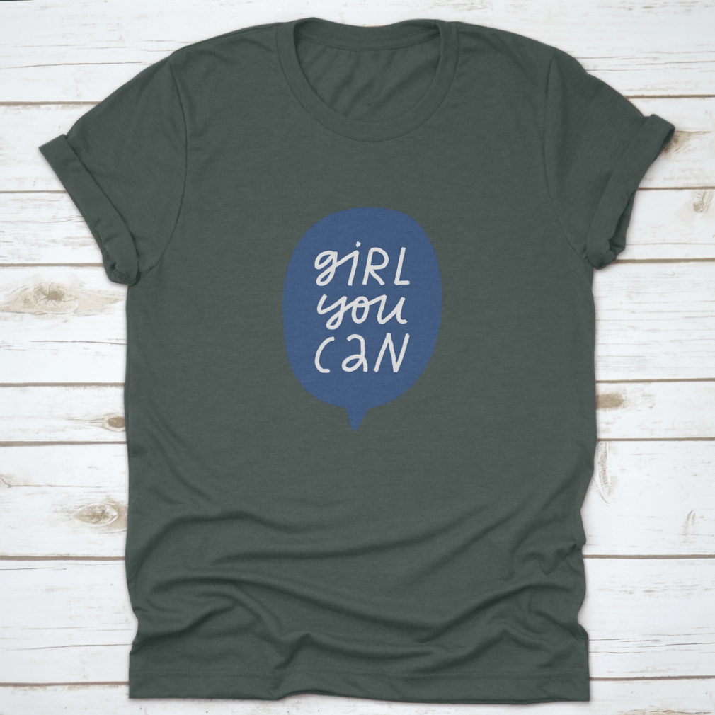 A stylish t-shirt featuring minimalist hand-drawn lettering in a blue speech bubble that reads 'Girl You Can', showcasing a casual and empowering design.