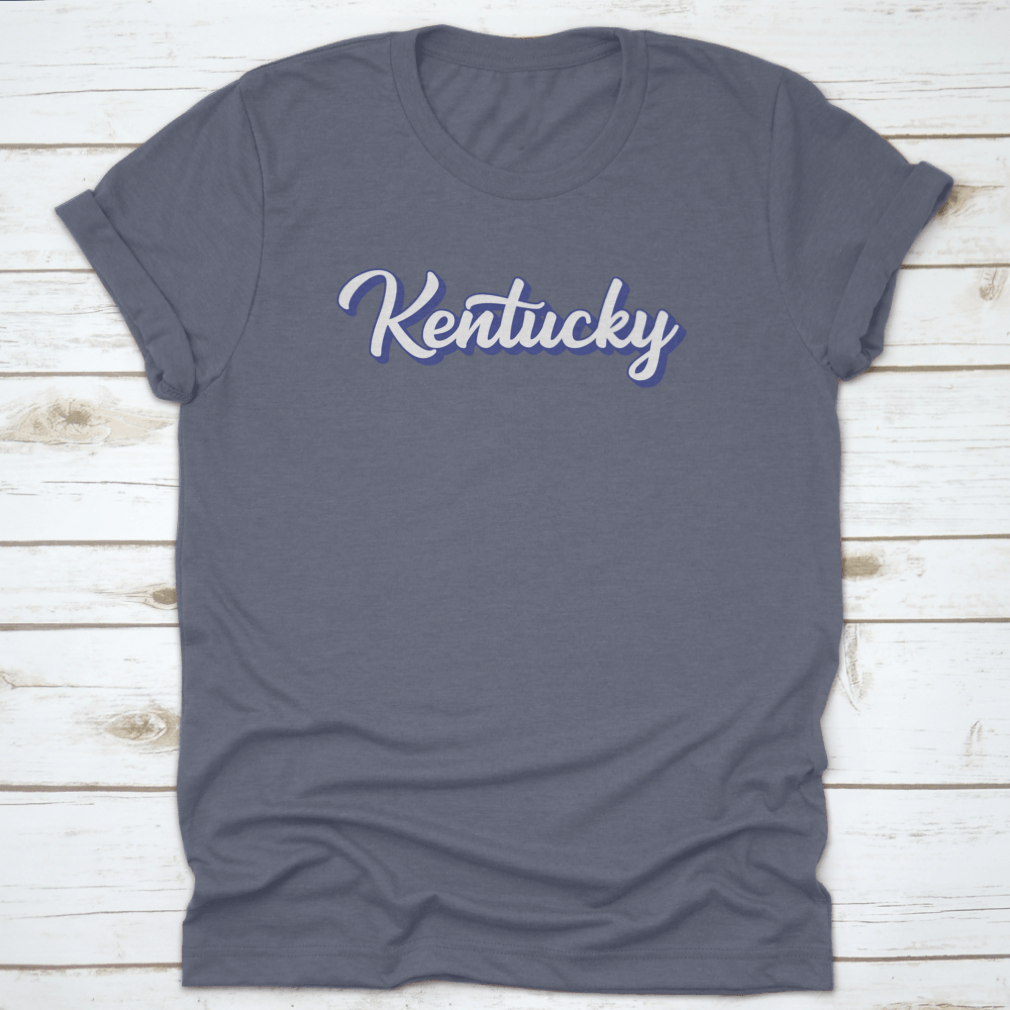 Modern blue hand lettering design of the state name Kentucky on a comfortable cotton shirt.