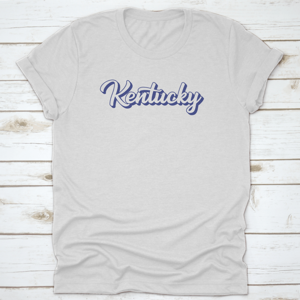 Modern blue hand lettering design of the state name Kentucky on a comfortable cotton shirt.