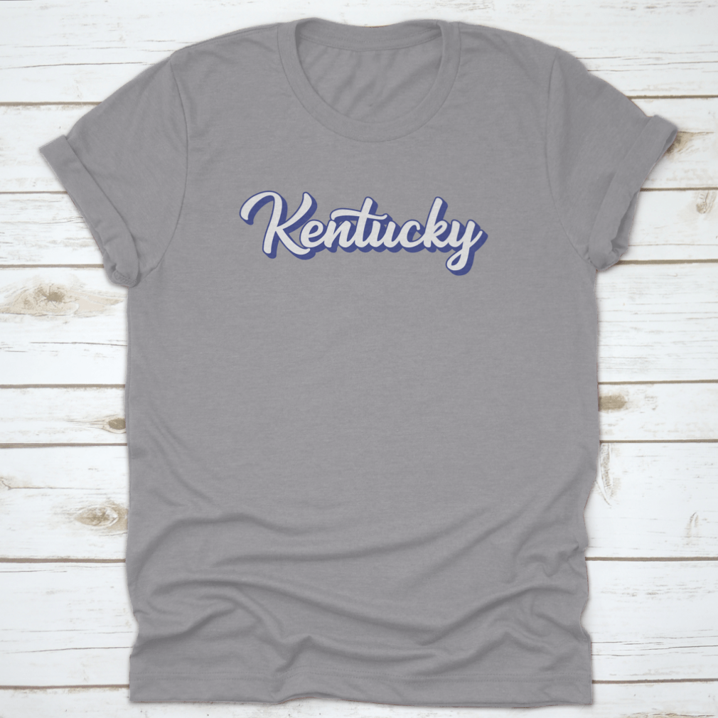 Modern blue hand lettering design of the state name Kentucky on a comfortable cotton shirt.