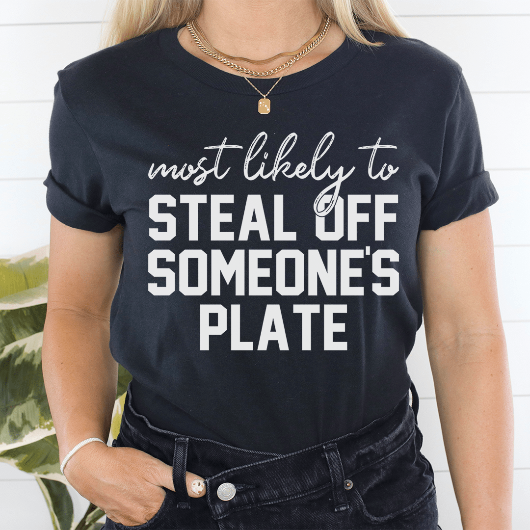 A comfortable Thanksgiving t-shirt featuring the phrase 'Most Likely To Steal Off Someone's Plate', made from soft cotton.