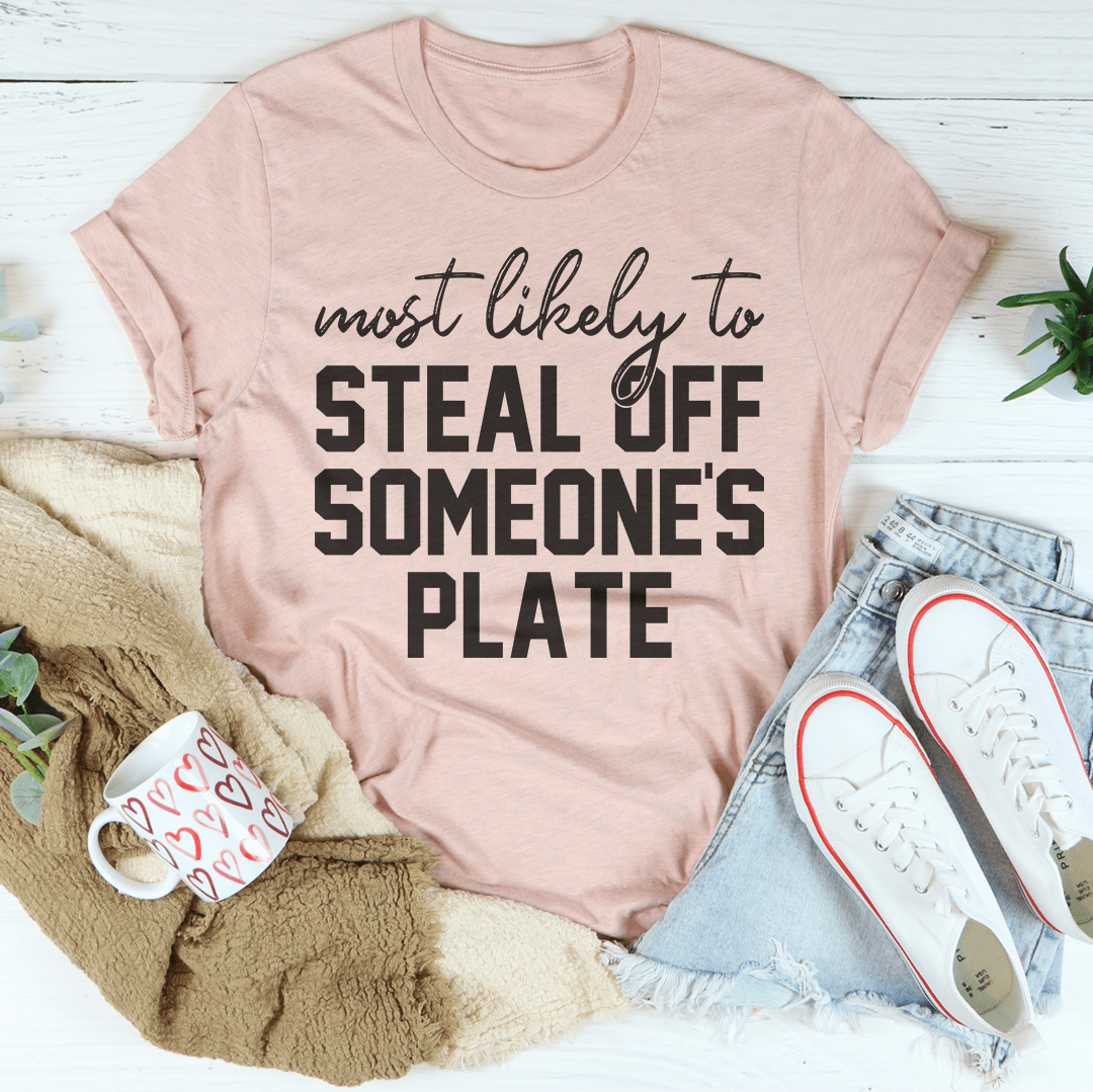 A comfortable Thanksgiving t-shirt featuring the phrase 'Most Likely To Steal Off Someone's Plate', made from soft cotton.