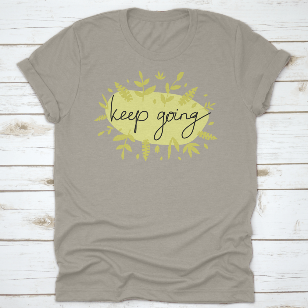 A stylish Motivational Message T-Shirt featuring modern lettering that says 'Keep Going', made from soft cotton fabric.