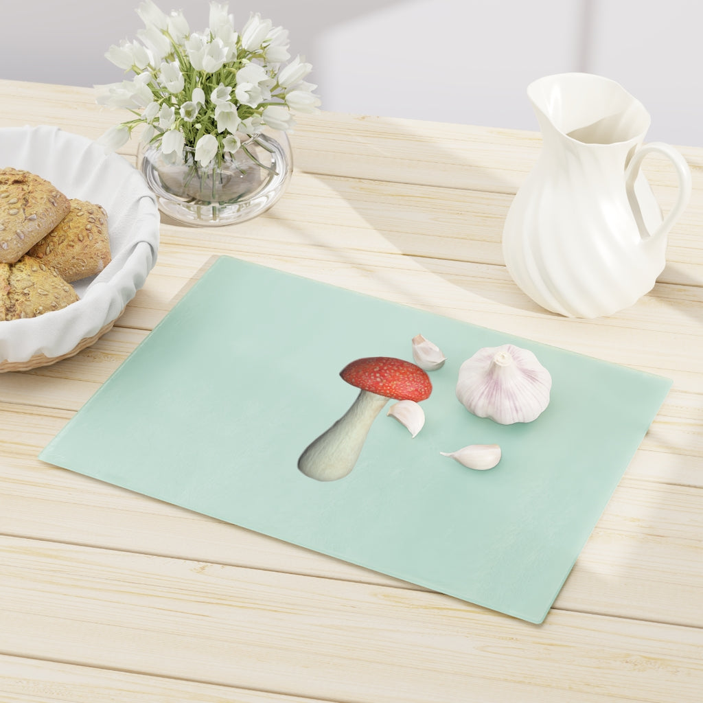 A stylish mushroom-themed tempered glass cutting board with rubber dots for stability, perfect for kitchen use.