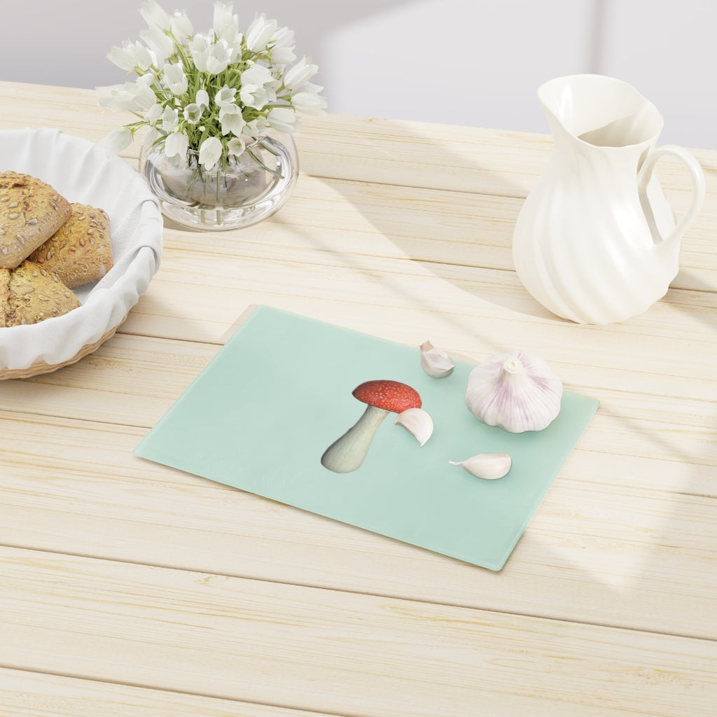 A stylish mushroom-themed tempered glass cutting board with rubber dots for stability, perfect for kitchen use.