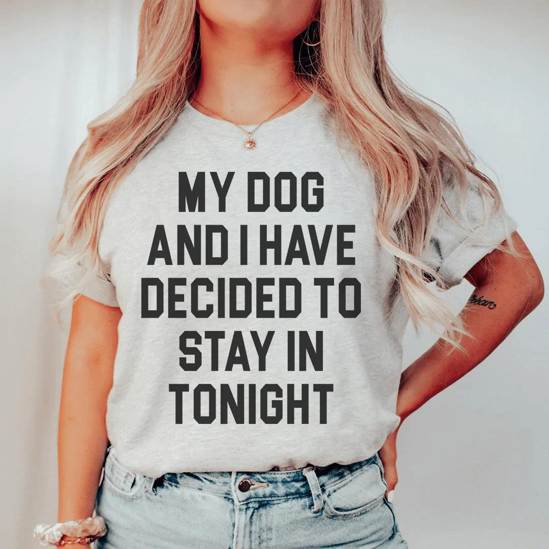 A cozy t-shirt featuring the phrase 'My Dog And I Have Decided To Stay In Tonight', made from soft ring-spun cotton with durable stitching.