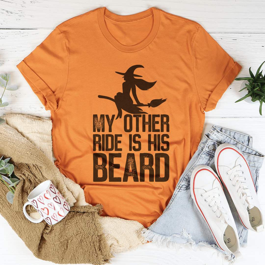 A humorous t-shirt featuring the phrase 'My Other Ride Is His Beard', made from soft cotton with double stitching for durability.