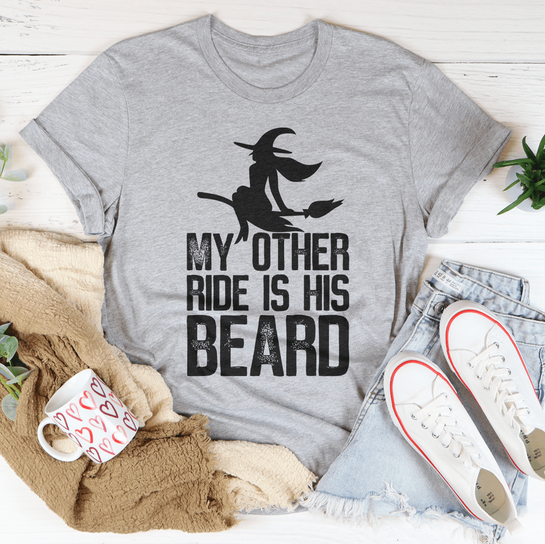 A humorous t-shirt featuring the phrase 'My Other Ride Is His Beard', made from soft cotton with double stitching for durability.