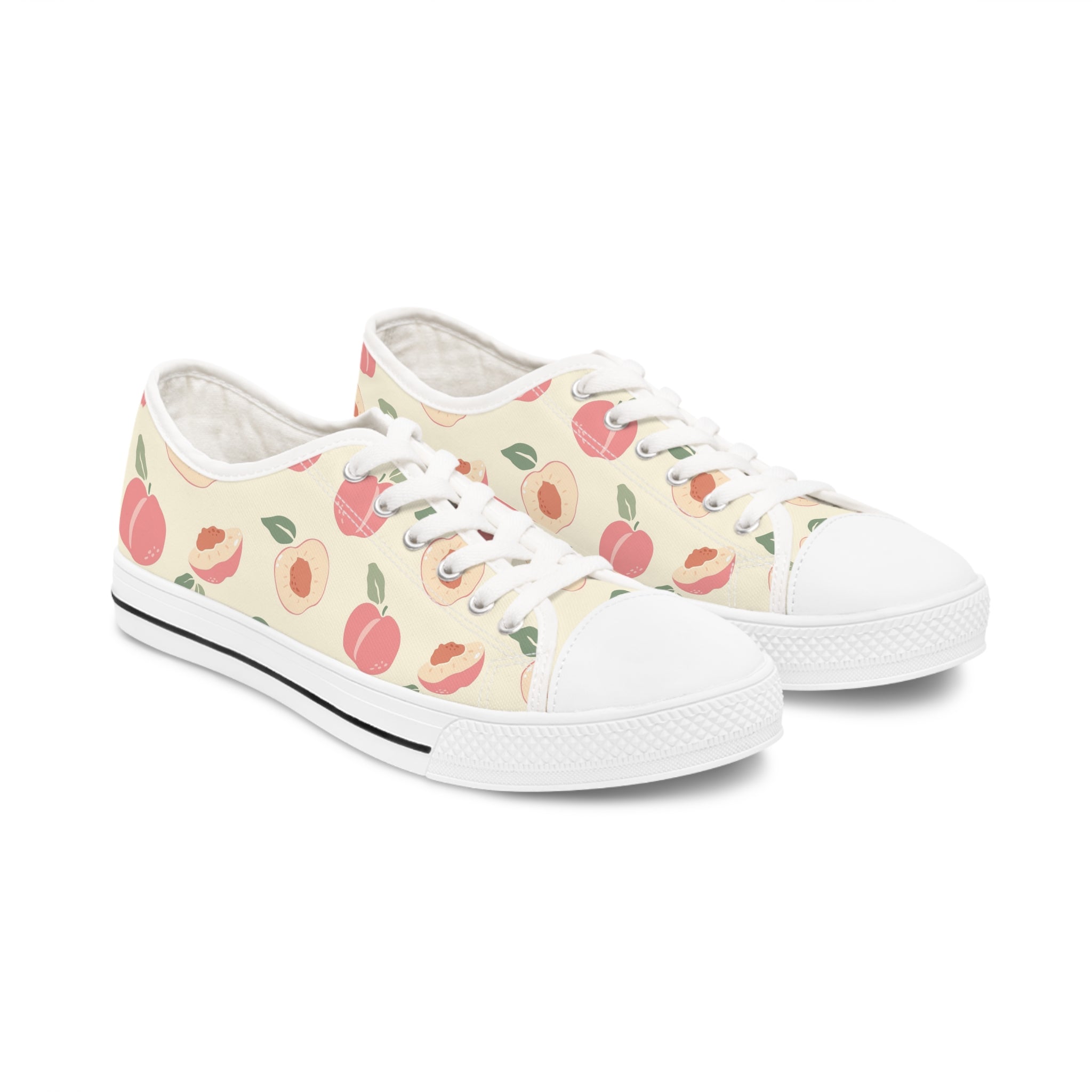 Nectarine Women's Low Top Sneakers in black and white with lace-up closure and silver metal eyelets, showcasing breathable canvas material.