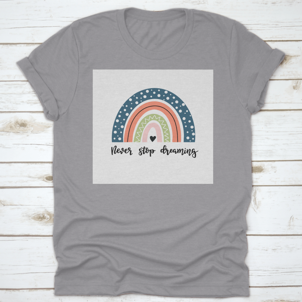 A colorful baby shirt featuring a rainbow design with the text 'Never Stop Dreaming' and 'Be Positive', made from soft cotton fabric.