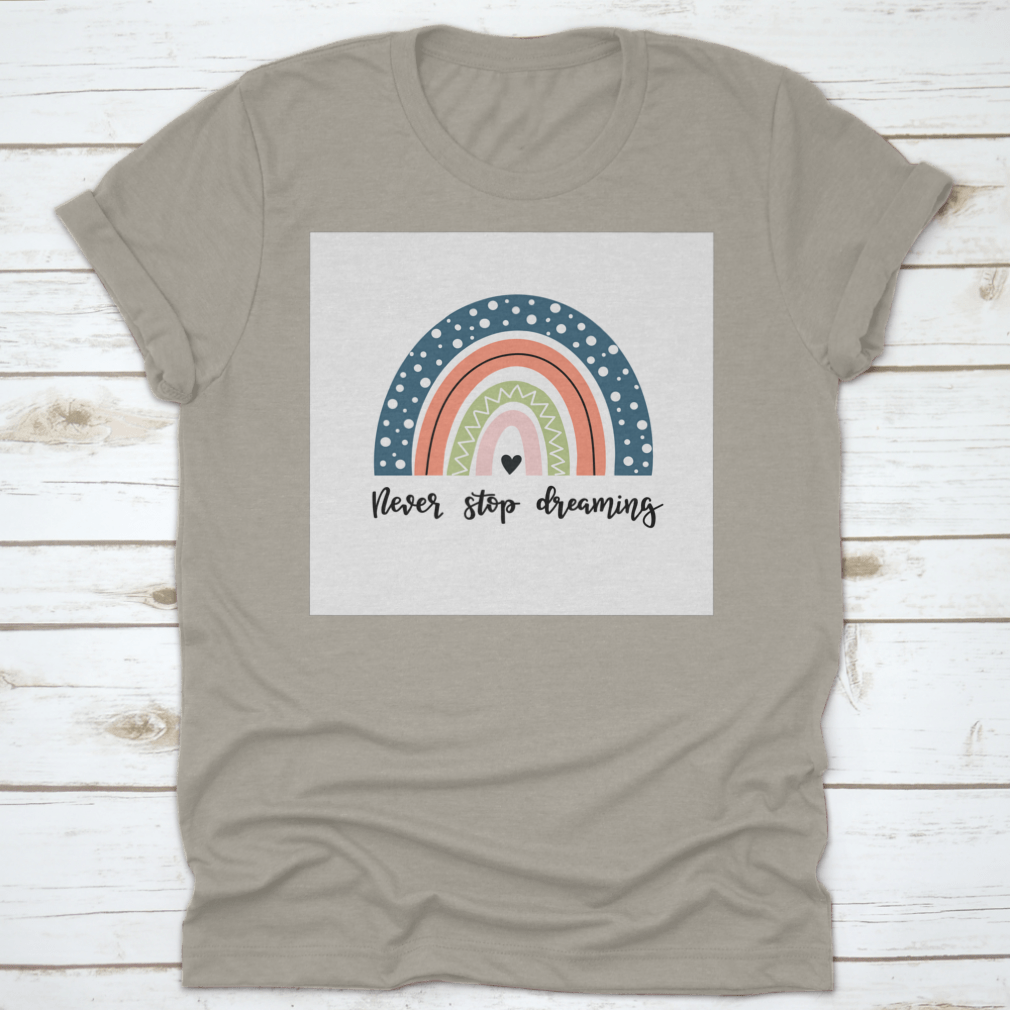 A colorful baby shirt featuring a rainbow design with the text 'Never Stop Dreaming' and 'Be Positive', made from soft cotton fabric.